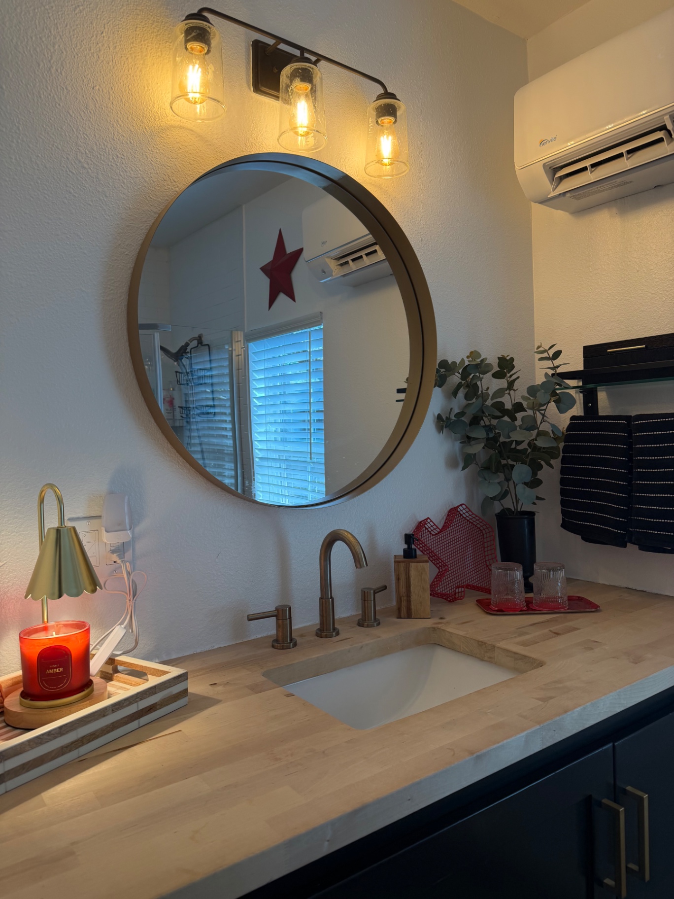Teal garage apartment behind the main house with a grassy backyard — Bathroom