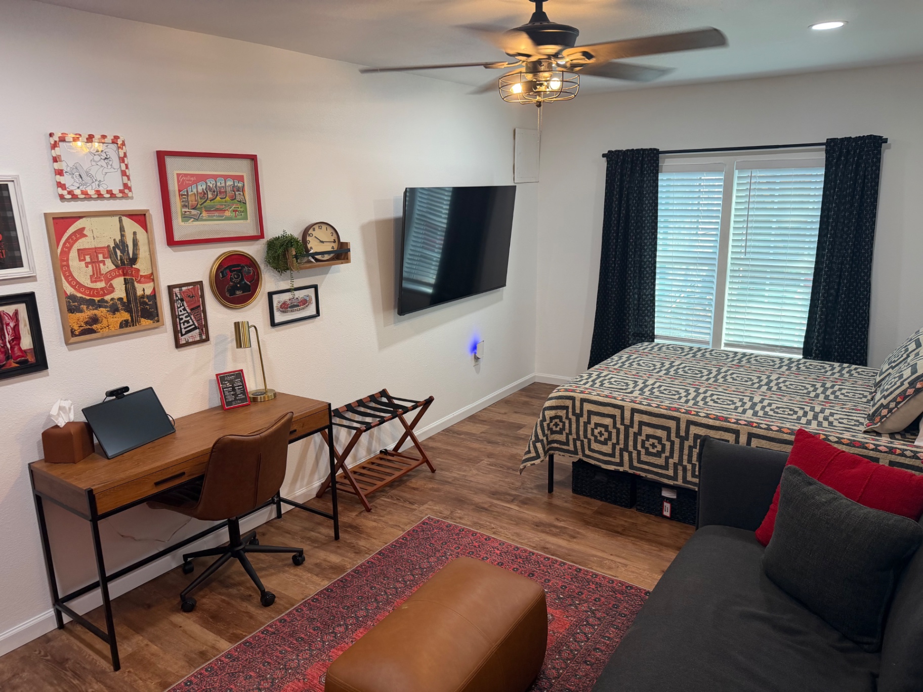 Teal garage apartment behind the main house with a grassy backyard — Queen bed & workspace